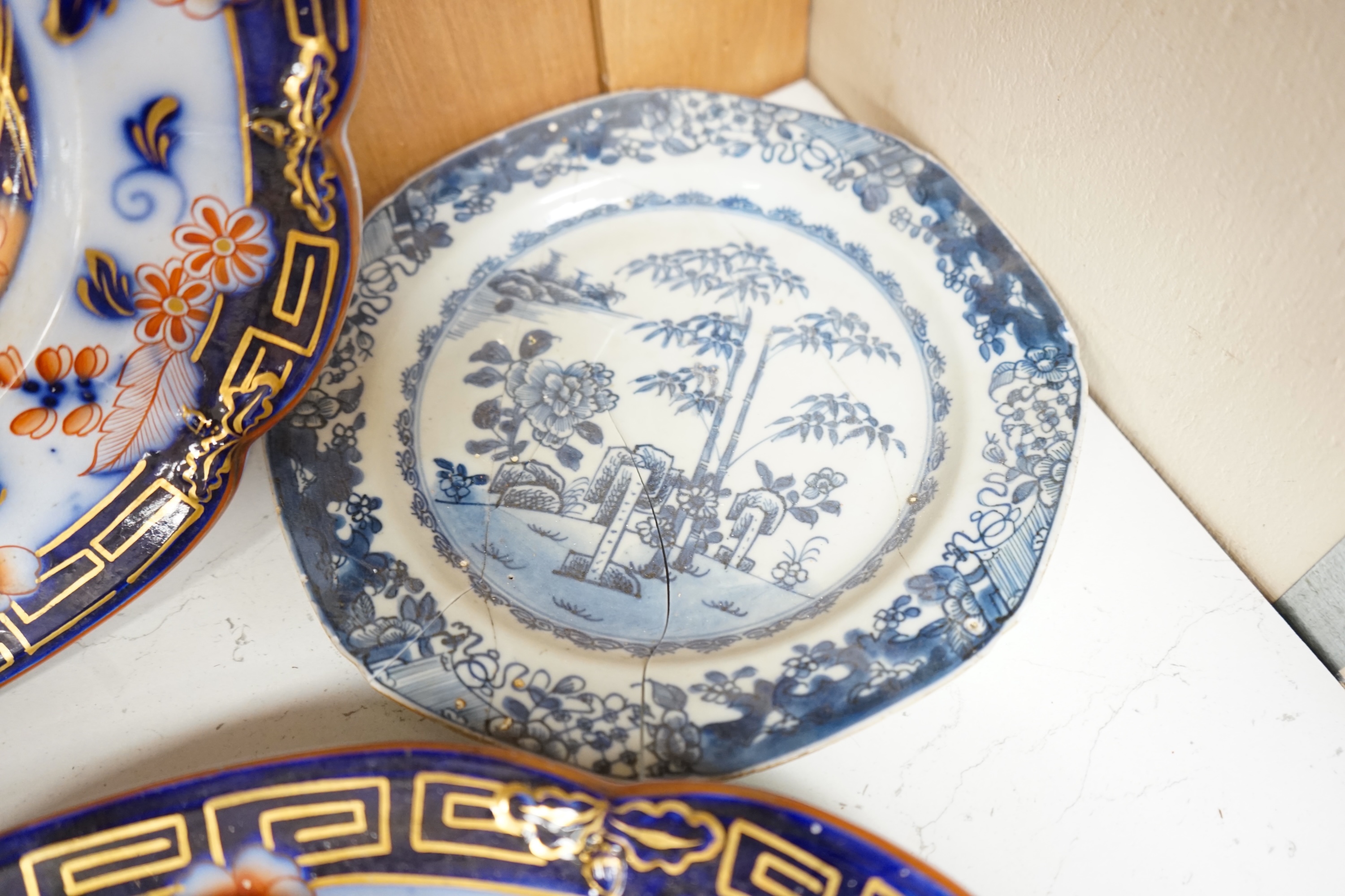 A Staffordshire flow blue ironstone part dinner service, comprising twenty-two 26.5cm diameter plates, seven 23.5cm diameter plates, ten 26.5cm diameter dishes, two small serving dishes and three large serving dishes, la